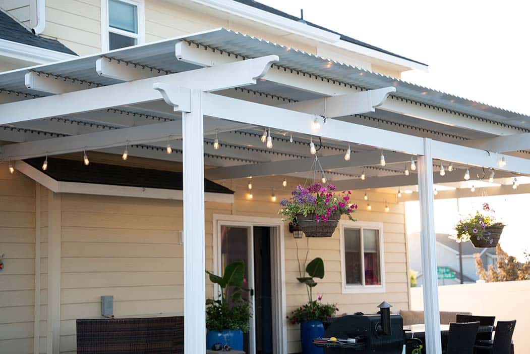 pergola with string lights and flowers